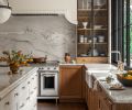 The counters and backsplash are Swan Quartzite from Architectural Surfaces. At the wash station, there&rsquo;s a Whitehaven farmhouse sink and Brizo Artesso faucet, both from Ferguson Home.