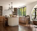 The cabinetry throughout is from European Custom Cabinets, including the reeded paneling on the island. Lind chose the Modern Schoolhouse Lantern from Visual Comfort & Co. to hang over the island.