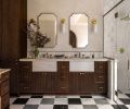 The vanity was fabricated with custom cabinets, an elegant neutral countertop, and Brizo Invari faucets from Ferguson Home. The tri-color marble floor nods to the home&rsquo;s existing checked floors in the entry.