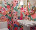 In the powder bathroom, Everitt embraced color with a multi-hued floral wallpaper from Rifle Paper Co. paired with an antique mirror, creating one of the home&rsquo;s boldest moments.
