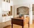 The remodeled kitchen is inviting and approachable with panel-ready appliances and a more manageable range size. A custom alder island design by Alana Spears adds warmth and functionality to the space.