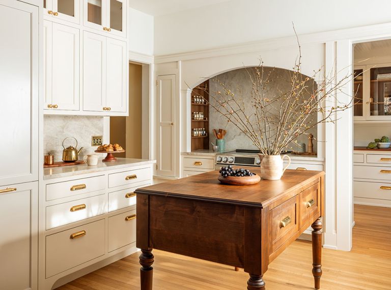 The remodeled kitchen is inviting and approachable with panel-ready appliances and a more manageable range size. A custom alder island design by Alana Spears adds warmth and functionality to the space.