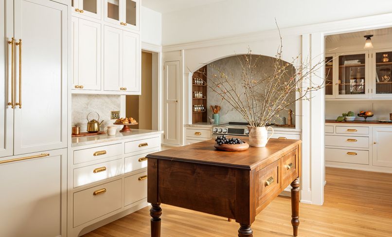 The remodeled kitchen is inviting and approachable with panel-ready appliances and a more manageable range size. A custom alder island design by Alana Spears adds warmth and functionality to the space.
