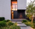 The entry has Shou Sugi Ban wood around it with a door by Finestra Design, Inc., from Kolbe Gallery in Seattle. The couple worked with Steven Yavanian Landscape Architecture and Nussbaum Group for the landscape design.