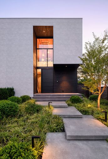 The entry has Shou Sugi Ban wood around it with a door by Finestra Design, Inc., from Kolbe Gallery in Seattle. The couple worked with Steven Yavanian Landscape Architecture and Nussbaum Group for the landscape design.