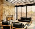 Under the pergola by Renson, there&rsquo;s an outdoor fireplace covered in Dekton cladding from Cosentino, as well as chairs, loveseat and table from Summer House. The pergola has a motorized louvered roof.