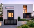 At the front of the home, there&rsquo;s a garage door from National Door. The architect specified Shou Sugi Ban siding in Gendai Black from Nakamoto Forestry, to wrap the bay window and entry, and contrast with the white cementitious panels.