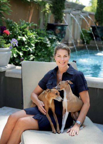 Lisa sits at right with her beloved Italian greyhounds at the foot of the pool. “I love the sound of the water spilling from the Cannons,” says Lisa, of the hot water that tumbles into the 4.5’ deep pool all summer long.