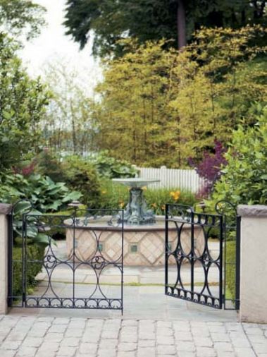 Boxwood and topiary are seen again in the larger garden, and even in the intimate courtyard, accessed from the motor court, which features a charming fountain designed by Larry Cavender.