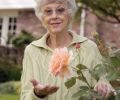 Susan Bates displays her favorite Rose, ‘Just Joey.’