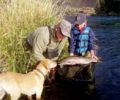 Fly Fisher’s Place guide Steve Erickson helps a young client with a steelhead to remember.