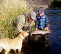 Fly Fisher’s Place guide Steve Erickson helps a young client with a steelhead to remember.