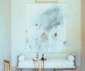 The furniture of Kasler’s own entryway may be antique but it is far from stuffy, with polka dots on the chair and pink leather on the stool – a color that reappears in other rooms in the home. The painting is by Steven Seinberg.