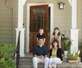 Portlanders Shawn and Sandy Patrick sit with their children, MacLean and Anna Blake, on the steps of their mudroom addition designed by Ann McCulloch.