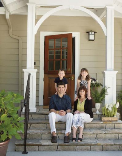 Portlanders Shawn and Sandy Patrick sit with their children, MacLean and Anna Blake, on the steps of their mudroom addition designed by Ann McCulloch.