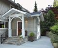 By removing two rows of rhododendrons and a retaining wall, designer Ann McCulloch made room for the addition with bike storage area at right.