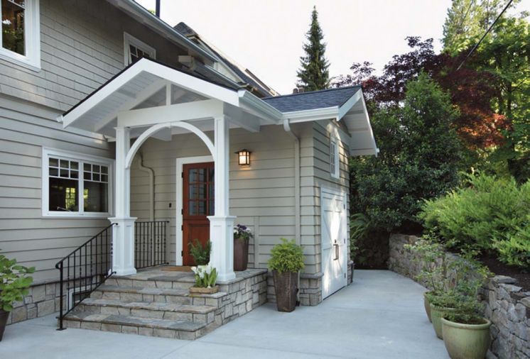 By removing two rows of rhododendrons and a retaining wall, designer Ann McCulloch made room for the addition with bike storage area at right.