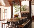 Designed by Martyn Lawrence Bullard, rock star Kid Rock’s Malibu retreat’s dining hall features a photo of Cuba by Michael Eastman. The dining room table from Dos Gallos was made from an antique French wine cellar floor. The nickel hanging fixtures are from Urban Archaeology.