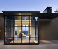 The formal entry sits outside of the private geometry of the house and within the courtyard. Using the same ceiling and floor surfaces on the outside and inside creates a place to welcome guests while still clearly separating the public space from the private home. Steel windows and stucco are elements used throughout the design.