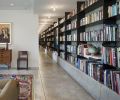 Cutting through the recreation room and the rest of the first floor, a 100-foot-long library provides shelving for books, display space and a visual spine to the lower level. The library’s construction materials also repeat the steel and concrete used elsewhere throughout the lower level.