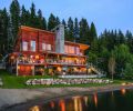 The Dillons’ lakeside house was constructed around a towering fireplace stack that was left in the original concrete instead of being dressed with stone or brick. The siding is set horizontally in contrast to the tall vertical windows. Metal, glass and concrete finish the exterior.