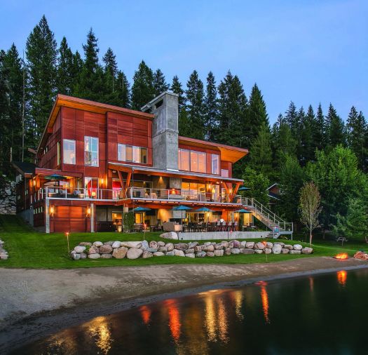 The Dillons’ lakeside house was constructed around a towering fireplace stack that was left in the original concrete instead of being dressed with stone or brick. The siding is set horizontally in contrast to the tall vertical windows. Metal, glass and concrete finish the exterior.