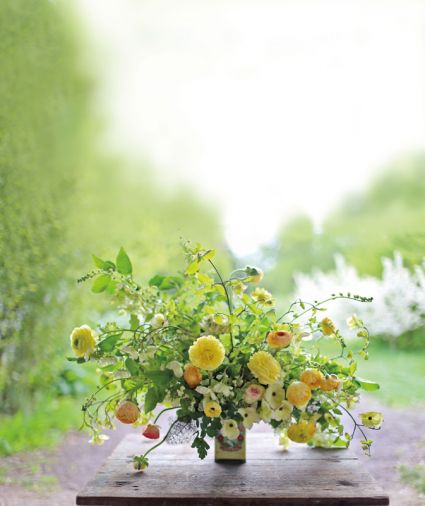 Sunshine & Rain: Spring flowers are particularly welcome in the Northwest, following those sometimes gray days of winter. This cheerful April arrangement incorporates dogwood, viburnum, bronze fennel, thalictrum foliage, ferns, and the ever-showy yellow ranunculus.