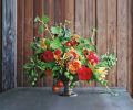 Garden of Eden: Edibles can add spice, texture and pops of unexpected color to arrangements. Shown is a mixture of scented geraniums, viburnum berries, nasturtiums, tomatoes, garden roses, baby apples, berries, crabapples, and grasses.