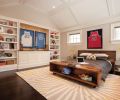In the son’s room, a low-slung, roughhewn bed crowned with basketball memorabilia echoes a wall of built-in shelves.