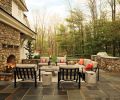 The uncovered patio area features thick cushions by Brown Jordan (Fremont Collection). Updated cement and side tables from the Urban collection from Kannoa keep the patio area open when hosting lacrosse teams or friends for dinner.