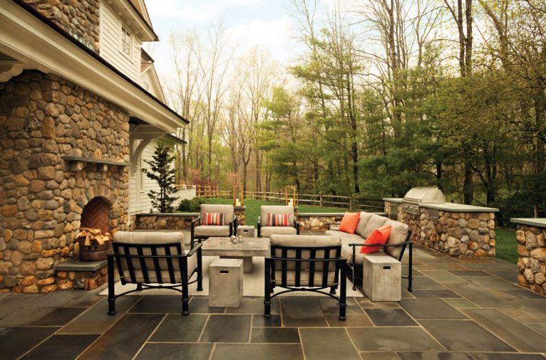 The uncovered patio area features thick cushions by Brown Jordan (Fremont Collection). Updated cement and side tables from the Urban collection from Kannoa keep the patio area open when hosting lacrosse teams or friends for dinner.