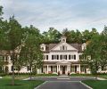 A lengthy front porch unifies the newly renovated Sechan home with such traditional Colonial design elements as cedar shingle gabled roof, dormers, double hung windows, and painted black louver shutters.