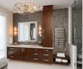 The master bathroom mixes the traditional design of its cabinetry with Silver Slate Faces of Natures mosaic tiles, a sleek towel warmer from Ferguson, and a stunning contemporary ceiling fixture by Corbett.