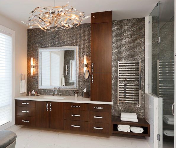 The master bathroom mixes the traditional design of its cabinetry with Silver Slate Faces of Natures mosaic tiles, a sleek towel warmer from Ferguson, and a stunning contemporary ceiling fixture by Corbett.