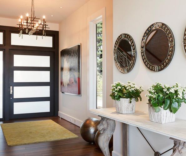 The Portland Millwork custom made ebony stained front door mixes with a citrine Kravet entry rug.