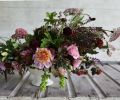 This moody bouquet designed by Erin Benzakein of Floret Flowers includes: grapes, coleus, amaranth, dahlias ‘Bracken Rose,’ ‘Twilight’ and ‘Crossfield Ebony,’ black queen anne’s lace, scabiosa, basil, copper beech, black elderberries, lisianthus, scented geranium ‘Chocolate,’ wheat, nine bark ‘Coppertina’ and thornless blackberries.