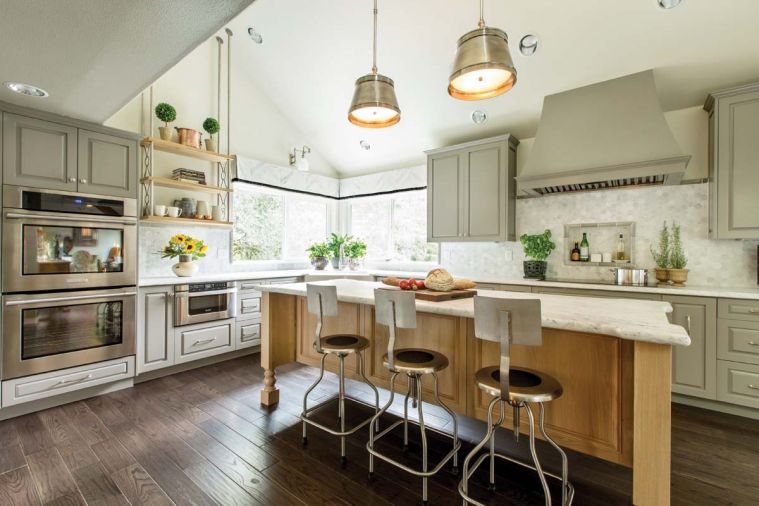 Homeowners in McMinnville, Oregon asked for a comfortable, functional and timeless European-inspired kitchen with modern touches in which they could cook and entertain for at least the next twenty years. Designer Jason Ball achieved their design goals by strategically placing classically styled cabinets along the walls, featuring a furniture-like center island and using modern stainless steel appliances and other metal finishes.