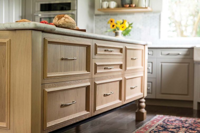 Much like a chef stages ingredients with mise en place at the ready, pots, pans and other kitchen equipment were measured and assigned to specific drawers in the center island to ensure that everything had its place. Built from sustainably harvested oak, the island also provides a gathering space where the homeowners and guests can mix and mingle.