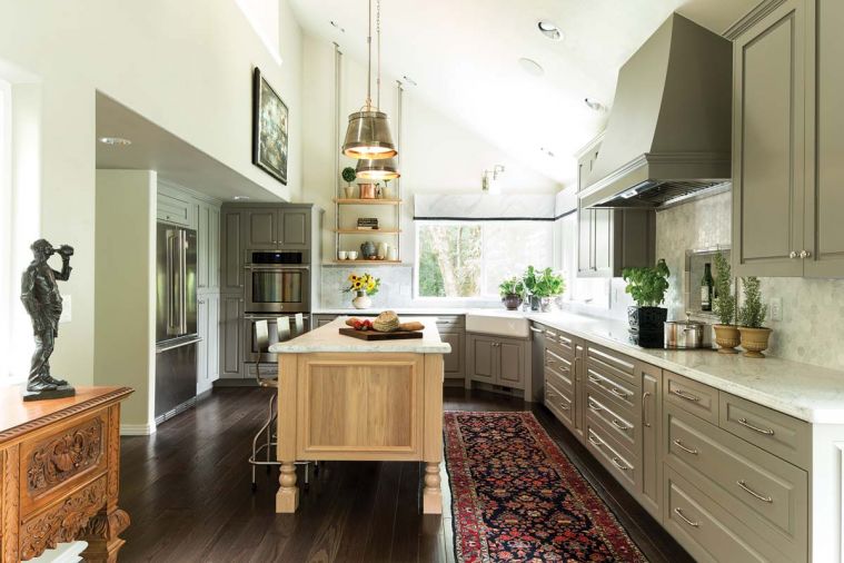 Pendants shed ample light while their metallic finish is echoed around the room in the cabinet hardware, appliances, sink fixture and open shelving.