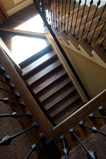 Stairs connecting the first and second floors have Appalachian oak treads and tiled risers. The balusters and railing were treated to the same espresso stain used in the den.