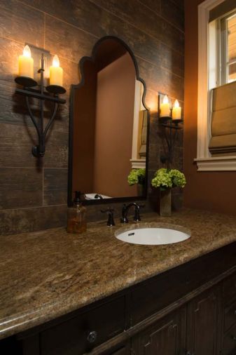 A Moorish styled mirror brings the Mediterranean ambiance to the first floor powder room.