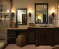 In the bathroom, cabinet design and granite counters are repeated from downstairs and Kohler sinks are mated with Delta faucets. To provide plushness under foot, the homeowner requested the floor be carpeted.