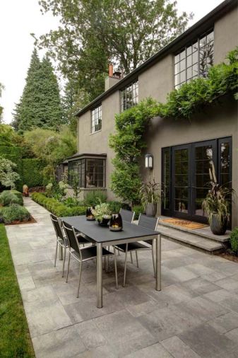 The new additions required a redesign of the landscaping at the top of the rear garden. 'Troy Clayton of Outdoor Spaces and I worked together to design those spaces,' says Benjamin. A Dania smoked glass table top on stainless steel base with fabric chairs provides an outdoor dining area. A pond stocked with 80 fish is thriving at the bottom of the garden.