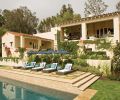 The swimming pool is bordered with flagstone pavers and Irish moss.