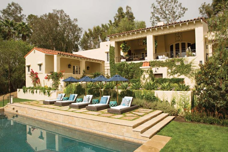 The swimming pool is bordered with flagstone pavers and Irish moss.