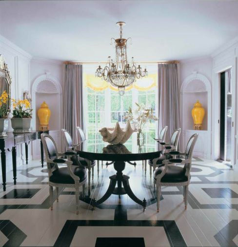 The elegant pedestal table and leggy Charles Frandin sideboard allow the geometrically patterned floor to be fully appreciated.