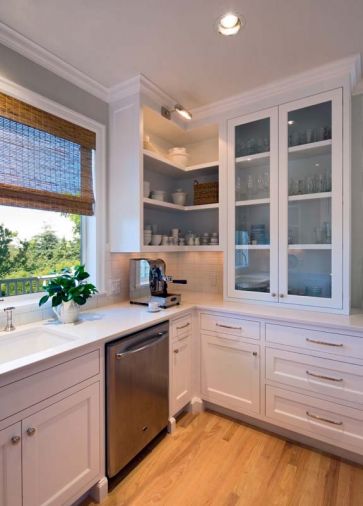 Drawer and cabinet pulls from Restoration Hardware add a homey touch of elegance. Easy to clean subway tiles accommodate practical, everyday use of the quartz countertop, fabricated and installed by Milan Stoneworks.