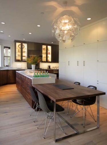 Backyard trees and adjoining Forest Park were echoed in the kitchen’s extensive use of wood. Western walnut from Crosscut Hardwoods was used for the bench, lower cabinets and island, while hand-scraped DuChâteau antique white flooring was used to provide a lighter, rustic tone in a practical floor.