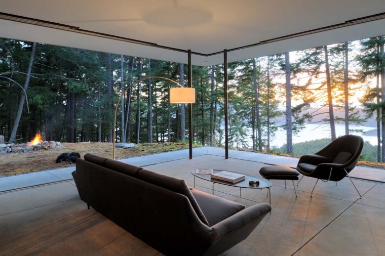 When the multi-panel sliding doors are stacked to either side of the living area, an unobstructed view opens to the San Juan and Canadian Gulf Islands to the West. Heated concrete floors can be activated from online when headed home from out of town. A pair of slim steel poles hold up the ten foot ceilings in the living area without compromising the view.