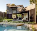 The reworked south façade lets light in through the innovative jalousie window and permits easy egress to the pool and backyard.